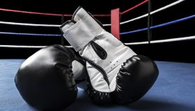 Black boxing gloves inside ring