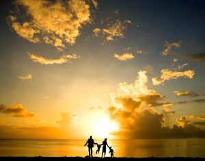 Silhouette of family on beach