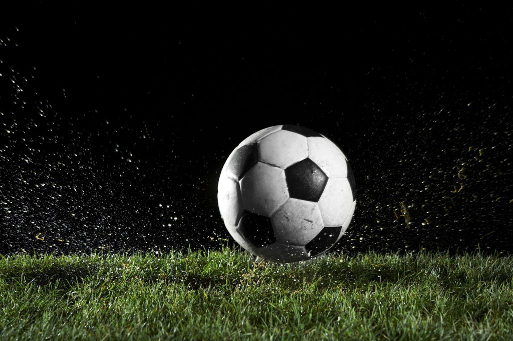 Soccer ball in motion over grass