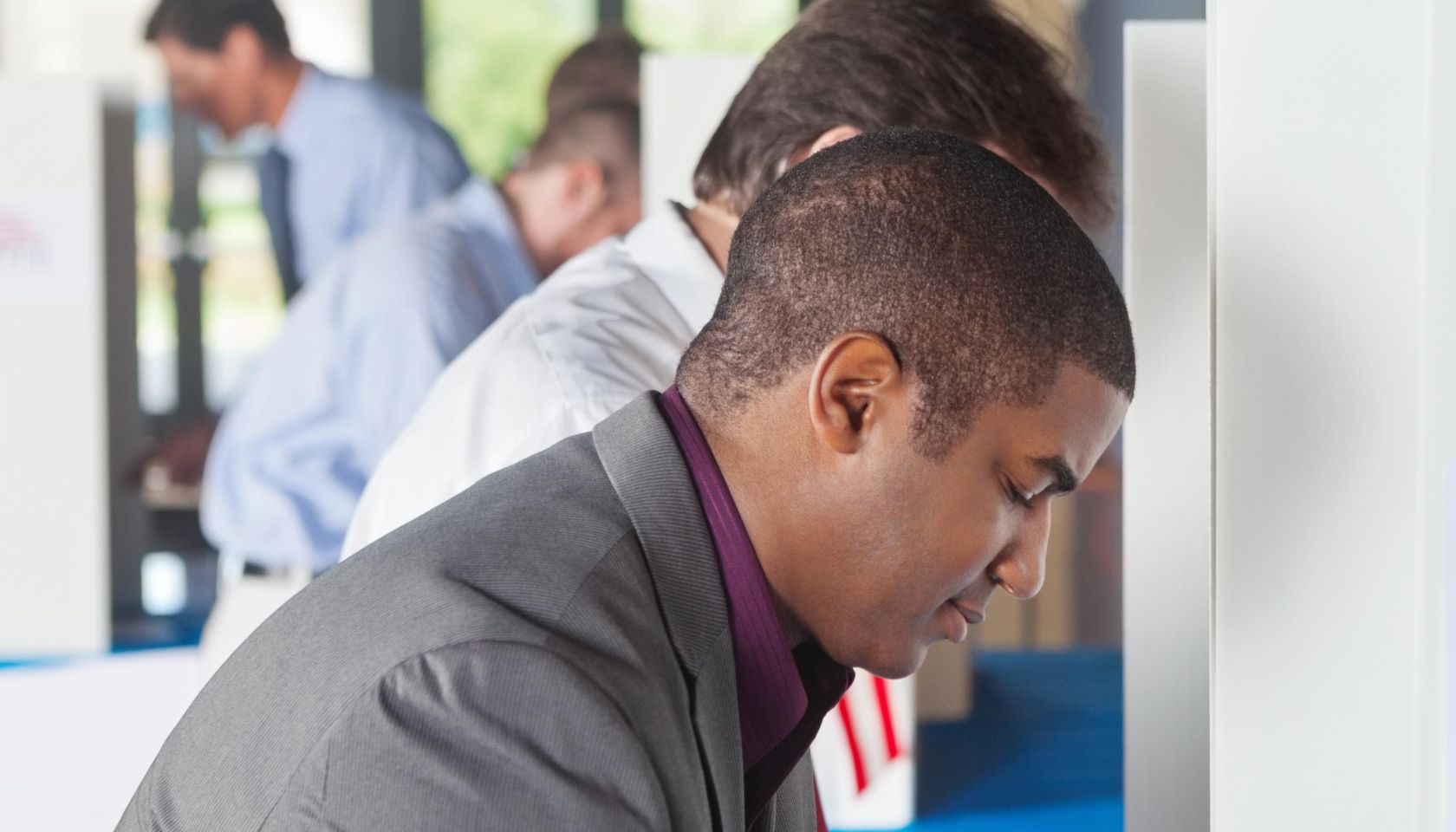 Man voting at a busy vote location