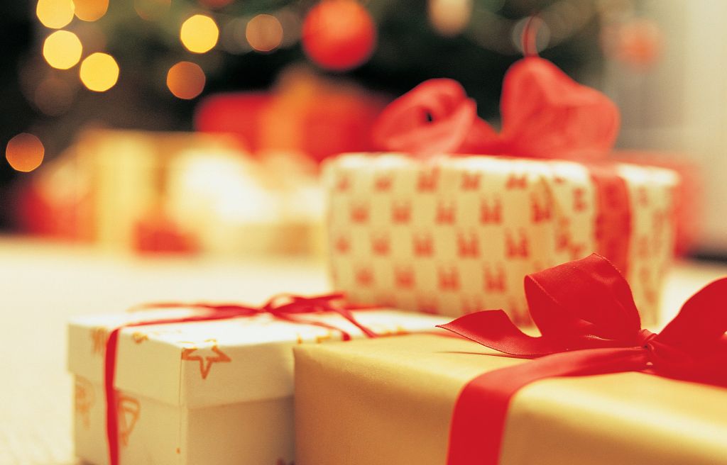 Close-Up of presents with Christmas Tree in background
