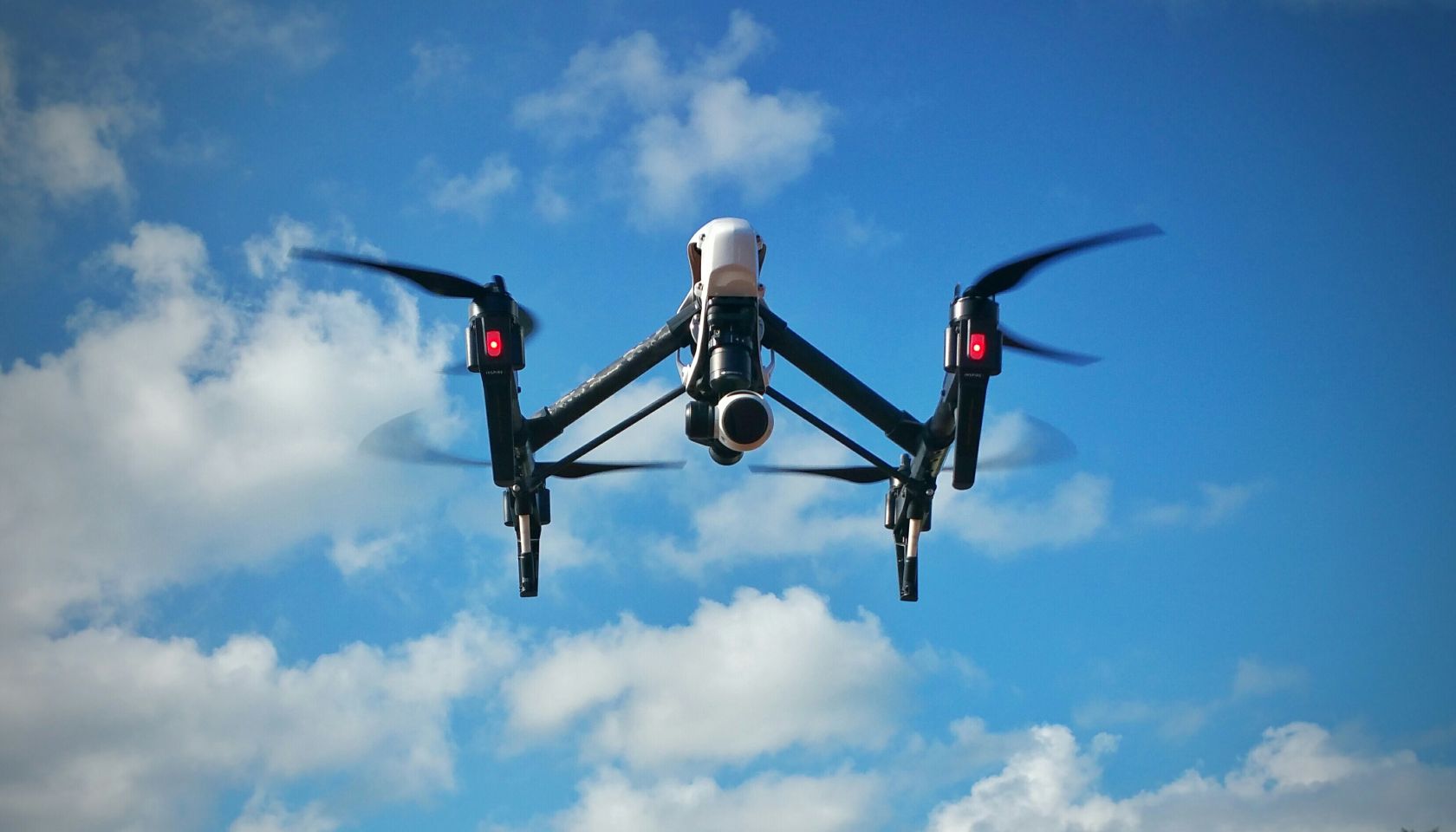 Drone With Camera Against Sky