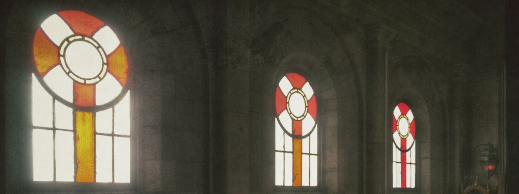 Stained Window Glass With Pews In Church