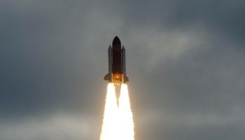 The Space Shuttle Endeavour flies into t