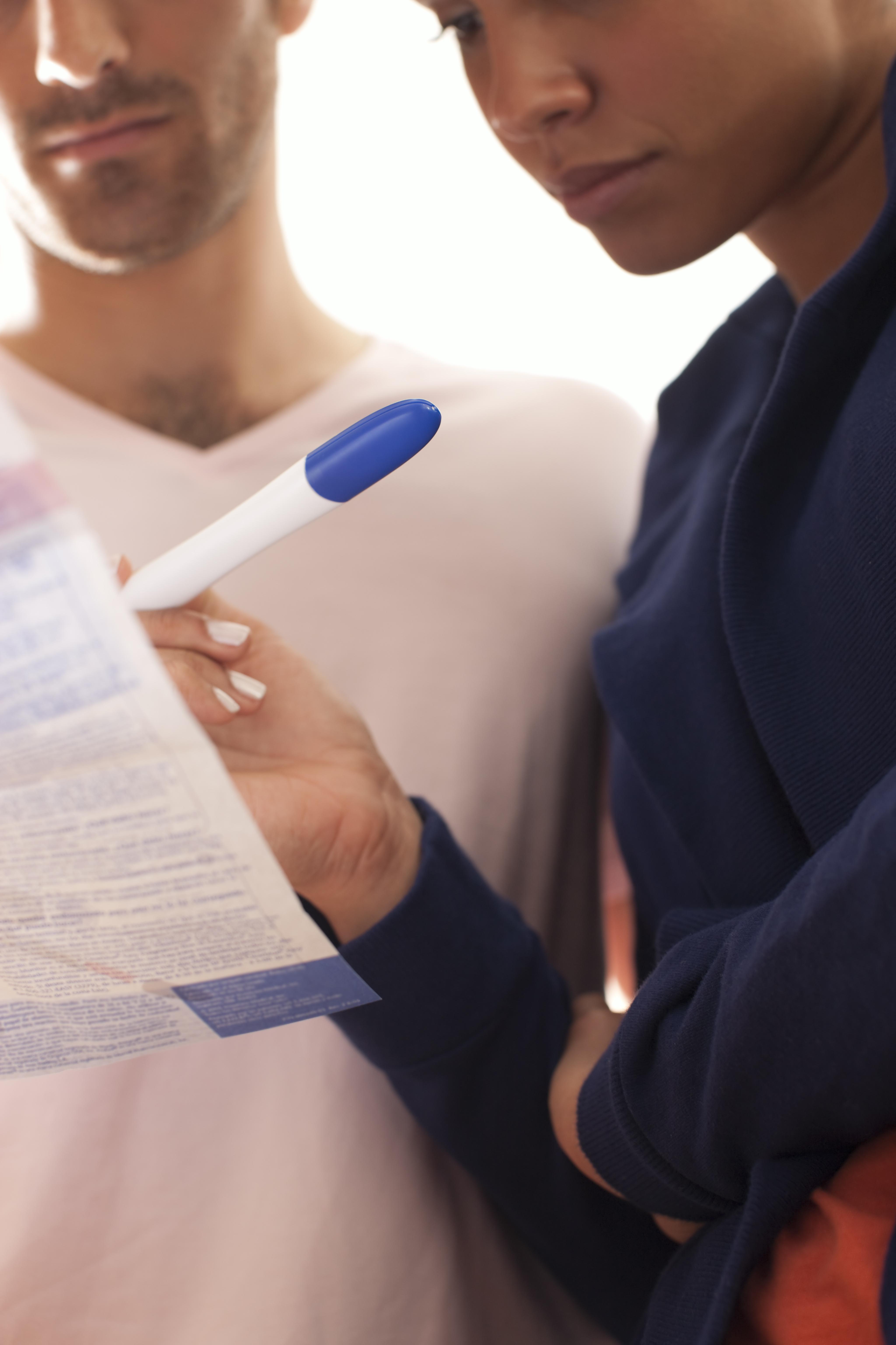 Couple taking a home pregnancy test.