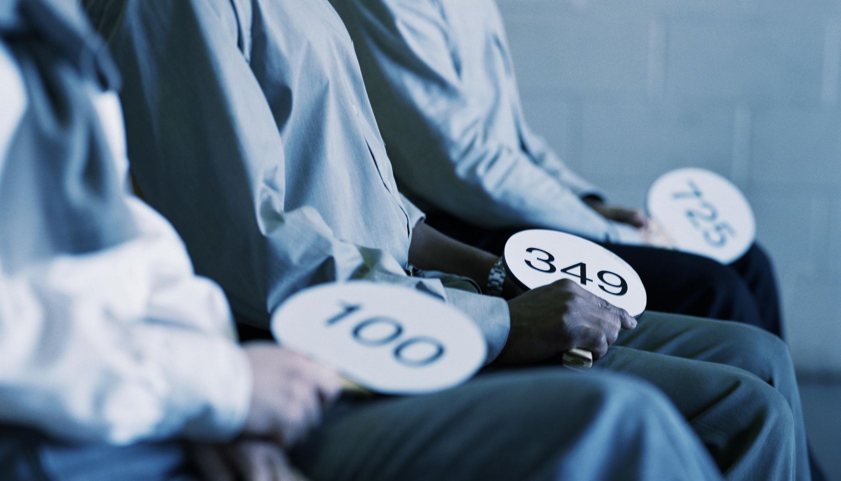 People holding auction paddles
