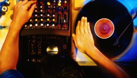 Disc jockey working with vinyl records, overhead view