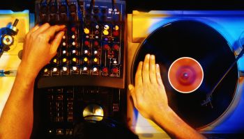 Disc jockey working with vinyl records, overhead view