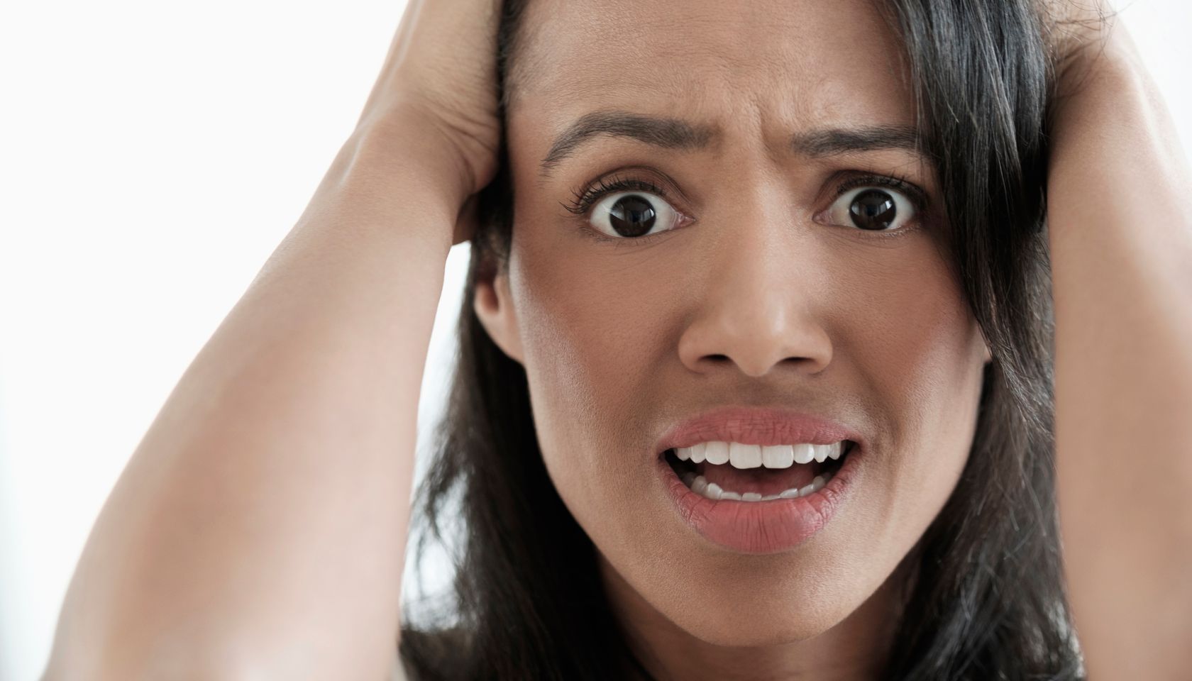 Close up of mixed race woman gasping