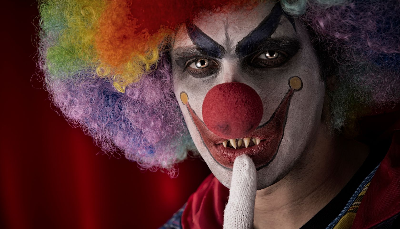 Creepy Clown with fingers on lips