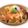 Close-Up Of Nachos In Bowl On White Background