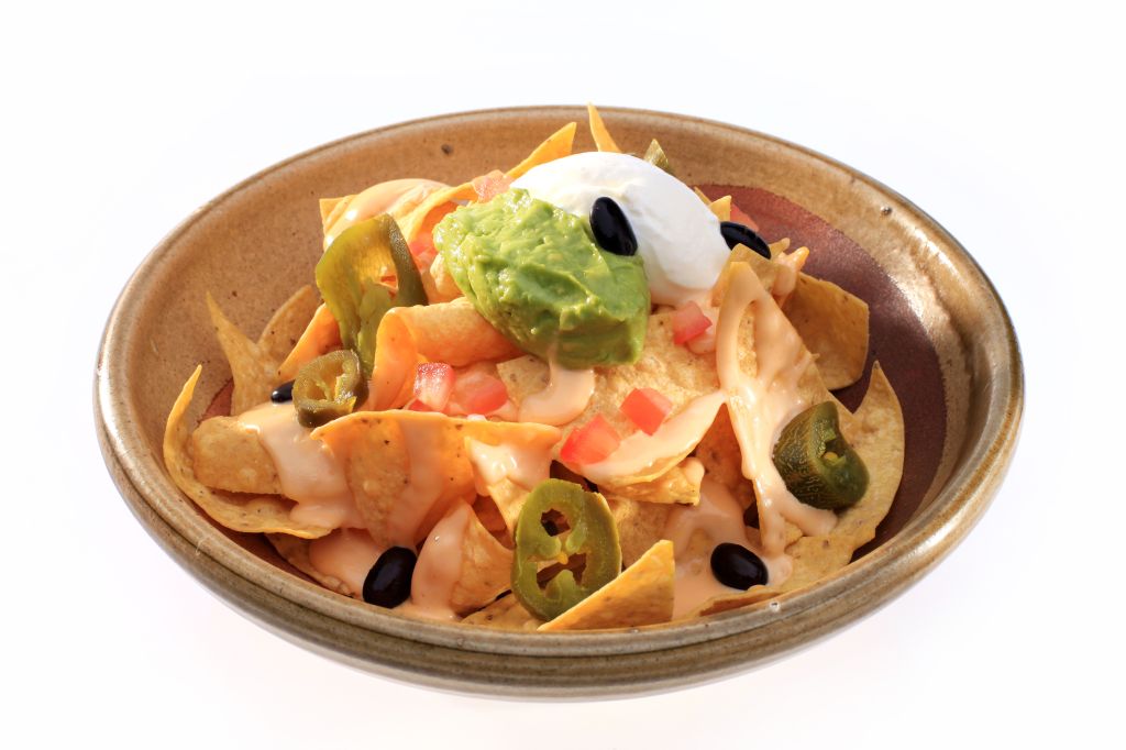 Close-Up Of Nachos In Bowl On White Background