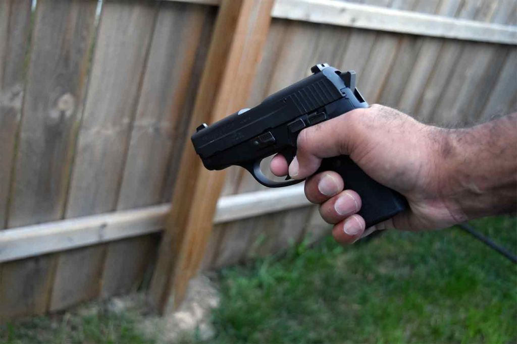 Man holding handgun pistol