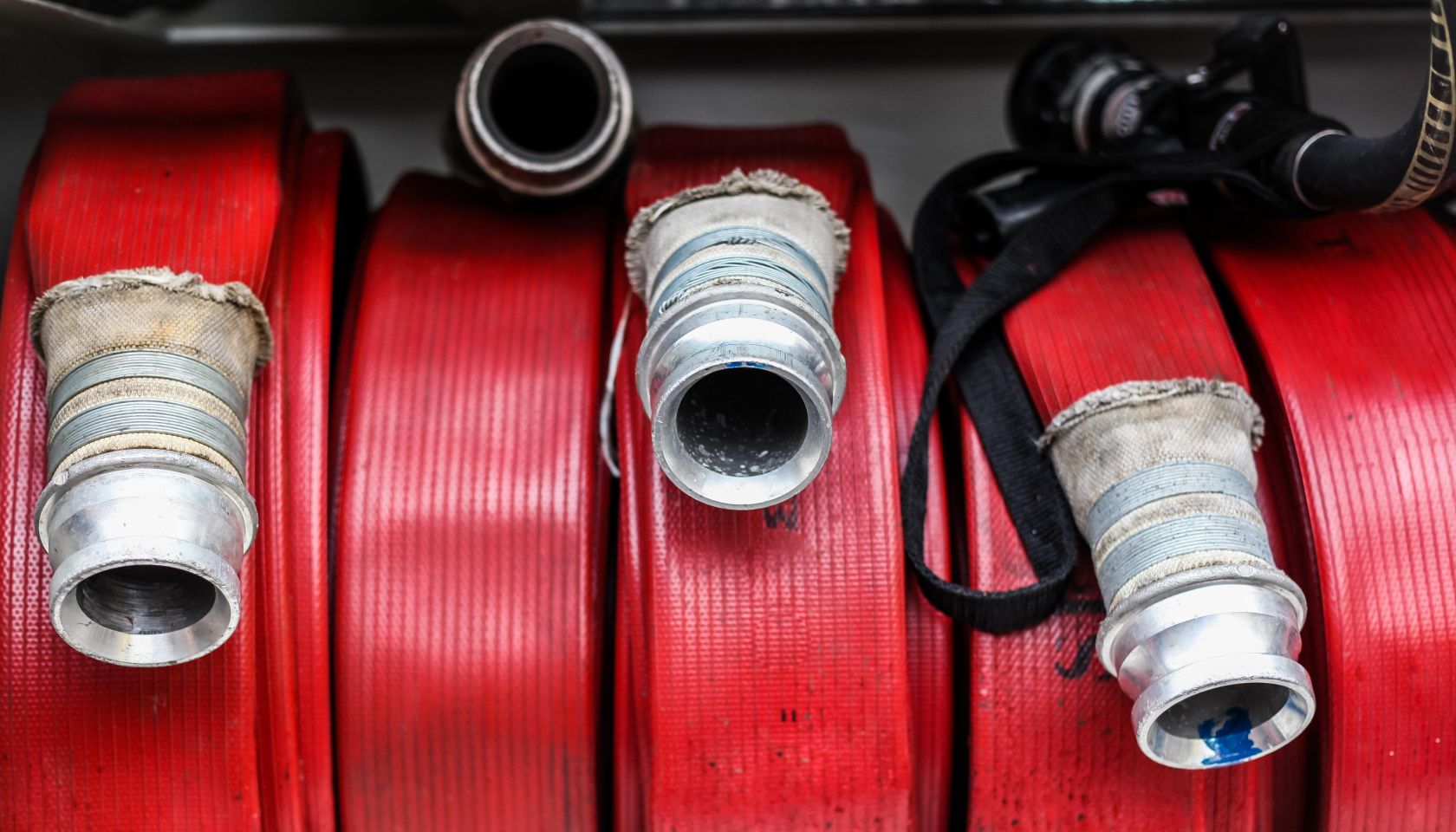 Red fire hoses on a fire engine