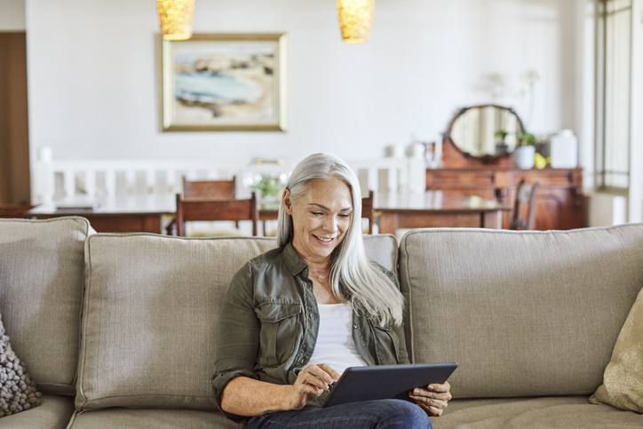 Woman using digital tablet at home