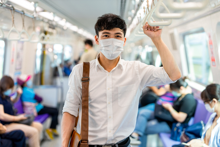 man with mask in metro