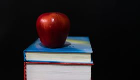 Red apple on books.