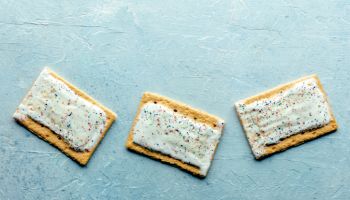 Pop tarts layout. Poptart toaster pastry with icing on a blue slate background