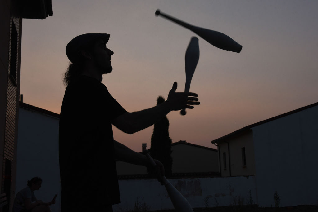 A man juggles at dusk in Rebollo de Duero, northeastern...