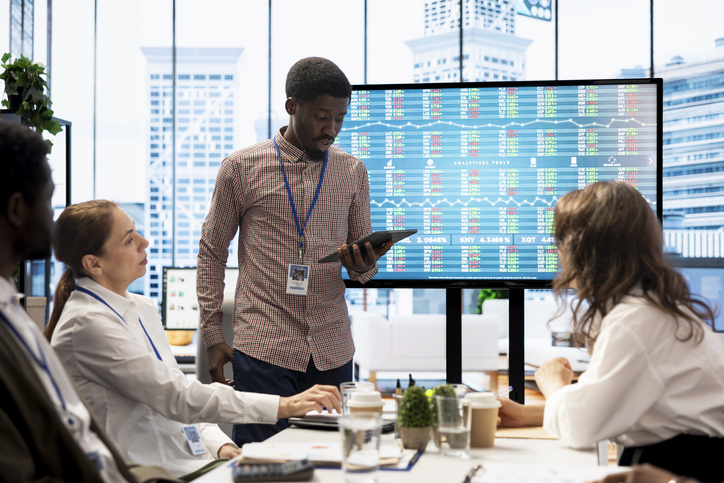 Team of company analysts reviews feedback on sales and orders