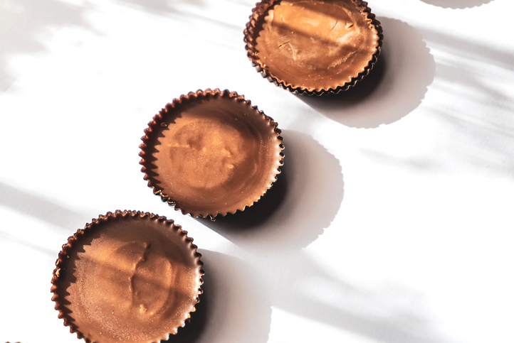 Peanut butter filled candy with chocolate frosting isolated on white background