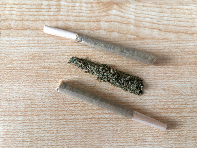 Rolled marijuanna flower joints on top of a table, pre rolls