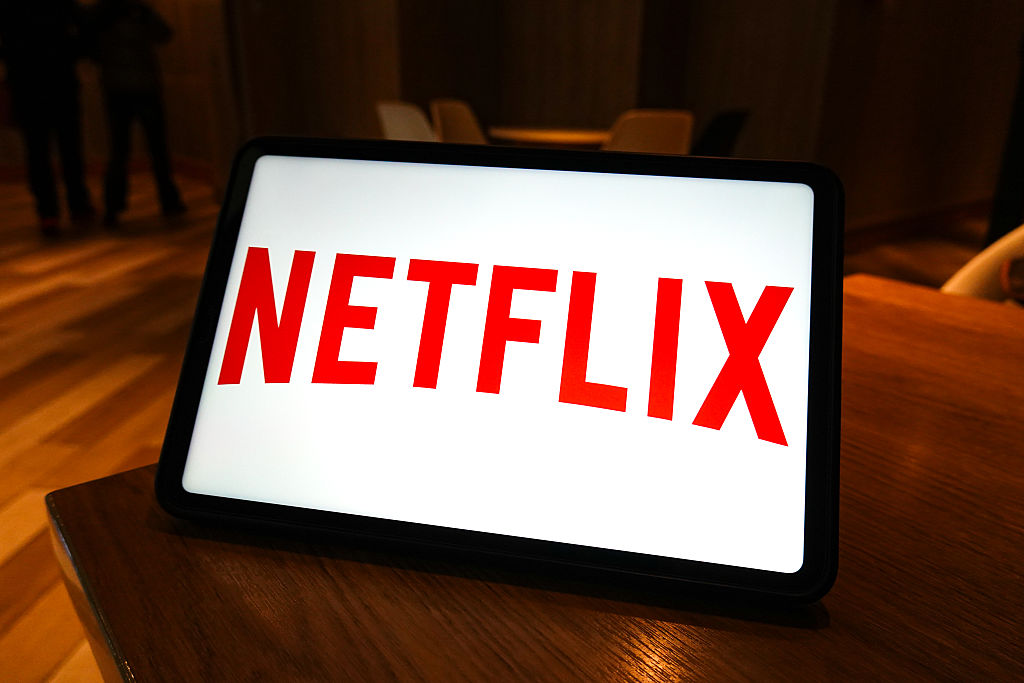 In this photo illustration, the Netflix logo is displayed on